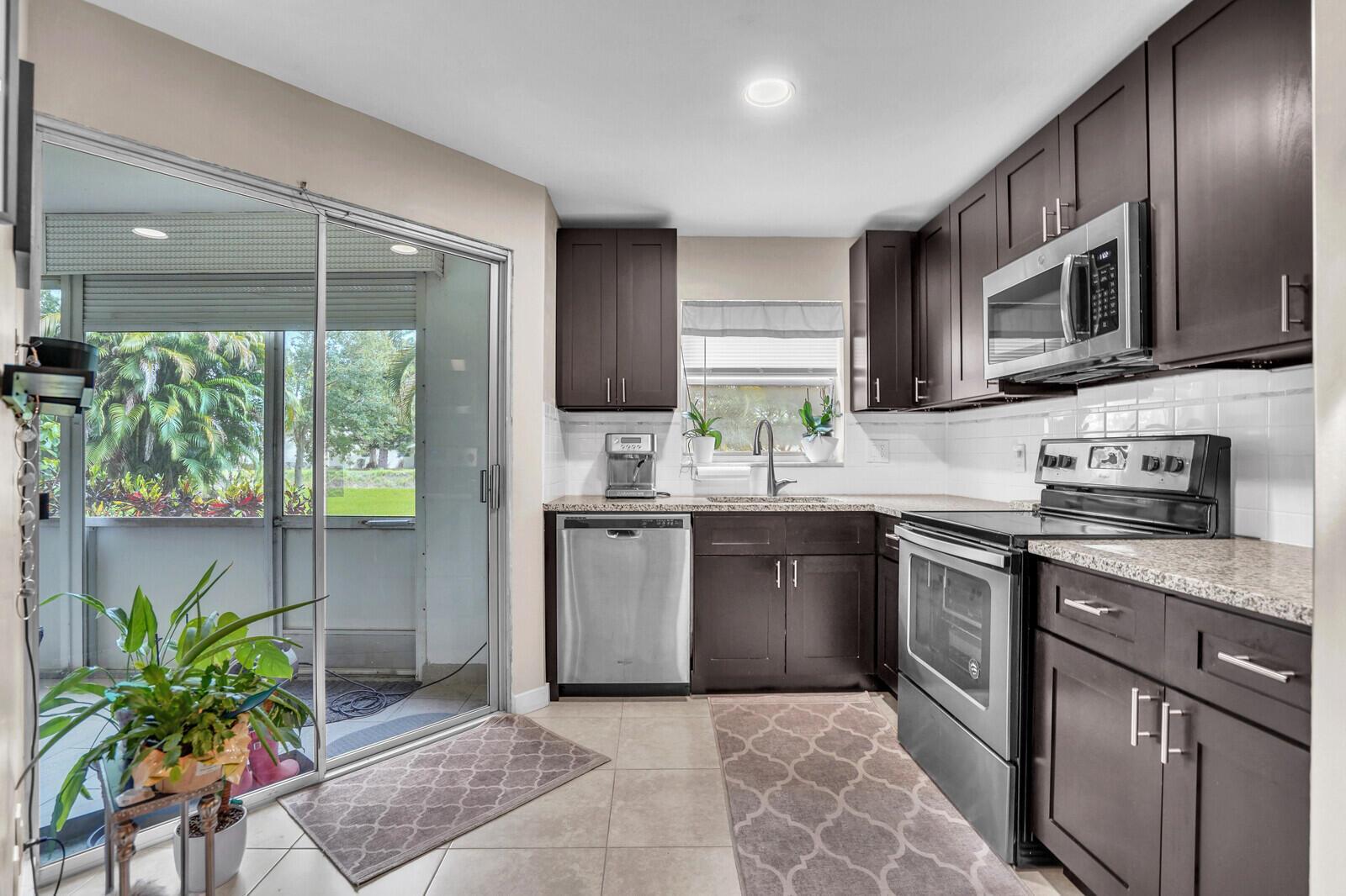 Move in ready 1st FLOOR condo in the desirable 55+ community of Poinciana. This gem features a large screened patio overlooking the garden and canal. Fully updated: expanded laundry room with full size washer and dryer, remodeled showers in both bathrooms, updated kitchen with stainless steel appliances, wood-look plank flooring, recessed LED lighting, updated electrical panel, and newer AC system with air purifier. Amenities include: pools, tennis courts, golf, fitness center, on site restaurant, and so much more.