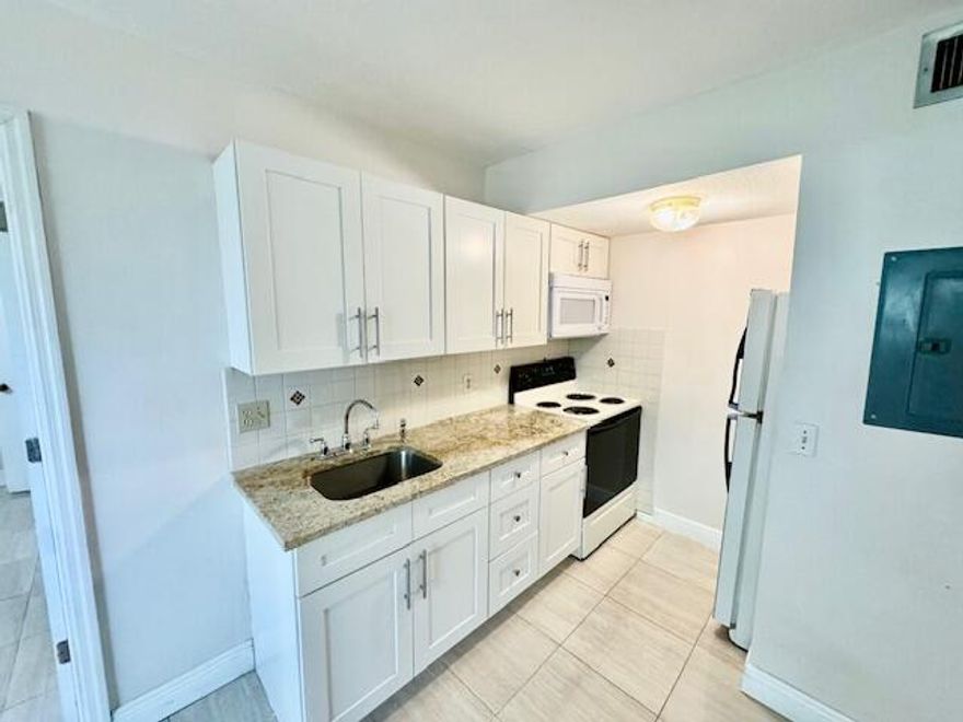 Impeccable and well-maintained 1-bedroom, 1-bathroom second-floor home in a convenient location. Features a spacious bedroom with walk-in closet and an in-unit washer and dryer for added comfort. Enjoy a large enclosed patio, perfect for relaxing or extra living space. Ideally situated close to restaurants and shopping, with easy access to major highways including the Turnpike and I-95, making commuting simple. A great opportunity for comfortable and convenient living.