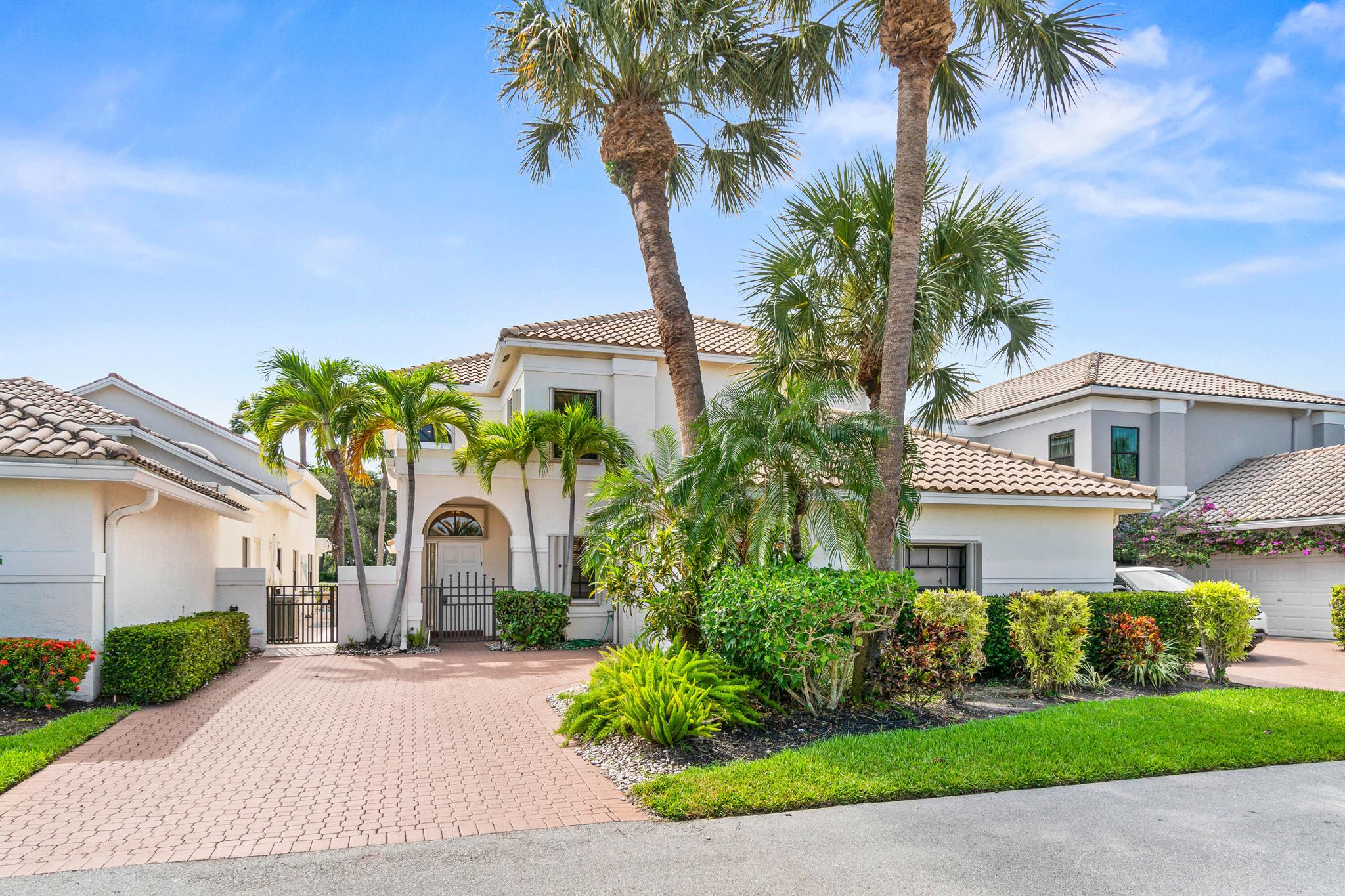 This is a fantastic opportunity to tailor a home to your personal style in the prestigious Polo Club. Featuring a highly functional floor plan, this two-story residence offers spacious and well-defined living areas that provide a strong foundation for future enhancements. On the main level, the layout includes all of the essential gathering spaces along with the primary suite. The living room, with its impressive volume ceilings, opens to a screened-in patio, a peaceful setting to relax and enjoy the surroundings. Adjacent is an expansive open patio, perfect for entertaining or simply soaking up the Florida sunshine. The kitchen is ideally connected to the dining area, creating a natural flow for hosting and everyday living. The primary suite offers privacy, ample closet space, and a