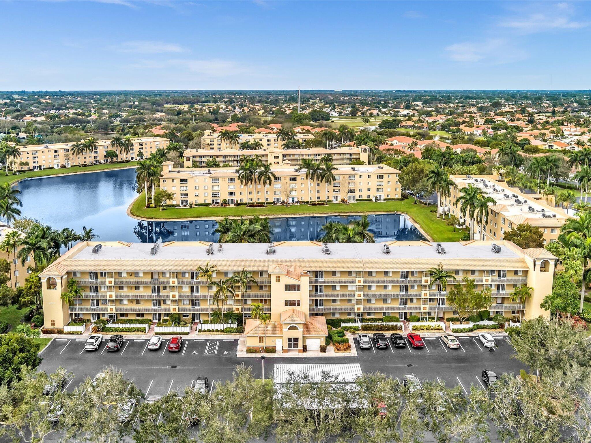 This 3/2 lakeview condominium is located in the gated Coral Cove enclave at Coral Lakes. The spacious & bright END UNIT boasts 1,869 square feet of living and is a short walk to the community's satellite pool & tennis/pickleball courts. The eat-in kitchen features timeless white cabinetry, large pantry and glass display cabinet doors. Other notable items include an expansive master suite with separate sitting area, 2 closets (1 walk-in) and a large primary bath with two vanities and separate shower & soaking tub. 3rd bedroom is currently configured as a Den/Office. Large in-unit laundry room and new water heater in 2021. Coral Lakes features a recently renovated 72,000 sq. ft. clubhouse with 640-seat theater, indoor/outdoor pools, cafe, fitness center, tennis/pickleball and more!