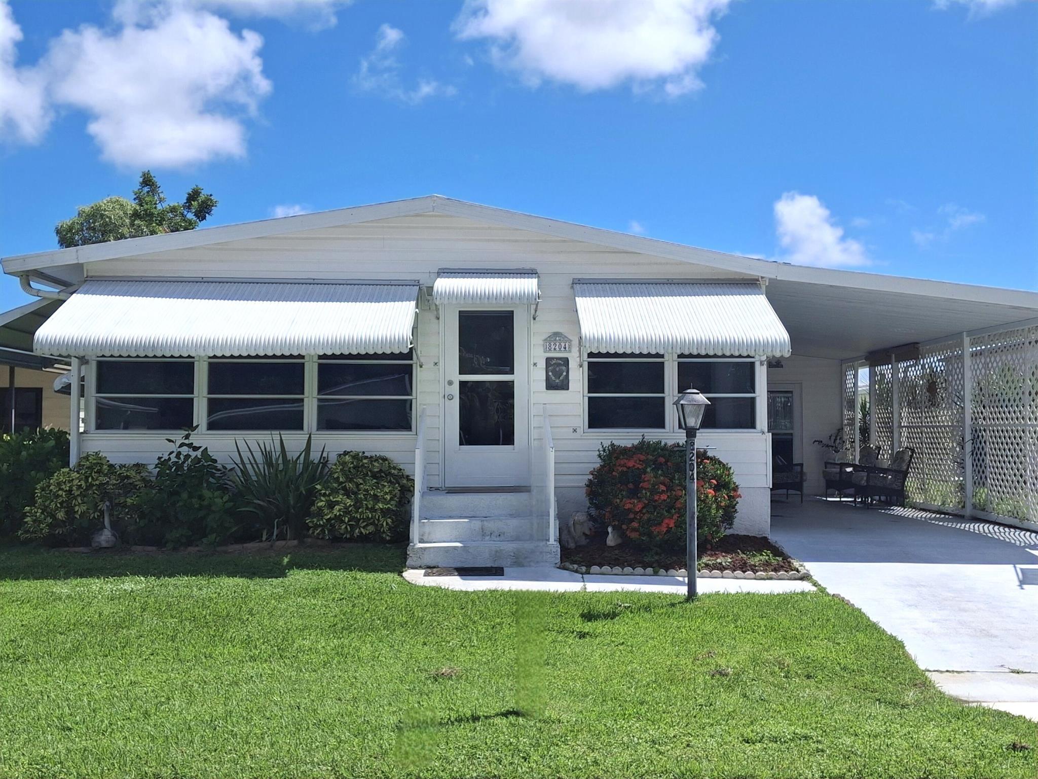 LAND OWNED, light & bright and cute as a button. Sold mostly furnished. See furniture exclusions. Move right in. Perfect for a vacation home with being mostly furnished and the reasonable pricing. Enjoy the extra large lanai, 23x10, with air conditioning for the summer months. The shed can even fit your golf cart and other storage needs. Double access door to the shed in back of home. New sprinkler system, new Levolor blinds in both the living room and lanai. Granite counter in the primary bath. Savanna Club is an active 55+ community with an 18-hole golf course, 3 pools, 3 clubhouses, an on-site-restaurant, a theater and so much more! Come enjoy this community which is only 10 minutes to a hospital, doctors, shopping and only 15 minutes to the beach.