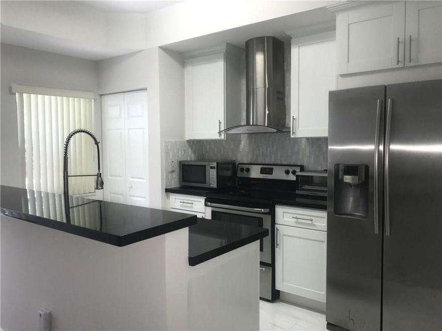 JUST LISTED!Extreme upgrades! Stunning lakeview corner 3/2.5 townhome. Complete modern kitchen upgrades with wood cabinets, crown molding, tile back splash, granite counters, ALL SS appliances and hood range. Upgraded baths with imported vanity from Spain, tile upgrades, TOTO toilets, frameless shower doors! All new wood and tile flooring with baseboards. Freshly painted, upgraded light fixtures, and new AC unit.  Gated community with pool. Close to 95,TP, and downtown. A must own turnkey property!
