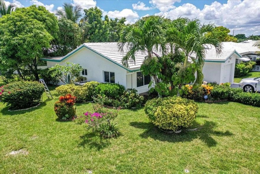 MOTIVATED SELLER! Fall in love the moment you pull up to this charming 2-bedroom, 2-bath corner lot gem in a vibrant 55+ community! This isn’t just a house—it’s your next happy place! Step into a remodeled designer kitchen with stainless steel appliances. The spacious family room can easily be used as a third bedroom, office, or media room—your choice! Enjoy bright bedrooms, upgraded bathrooms, and a laundry room with a washer and dryer. The new floors and loads of natural light make this home shine. New AC. Impact windows and impact garage door. The exterior is equally impressive-beautifully manicured landscaping, an inviting front porch, and fruit trees that add a tropical touch. This home offers the lifestyle you deserve. Low HOA. Don’t wait—schedule your showing today before it's gone!