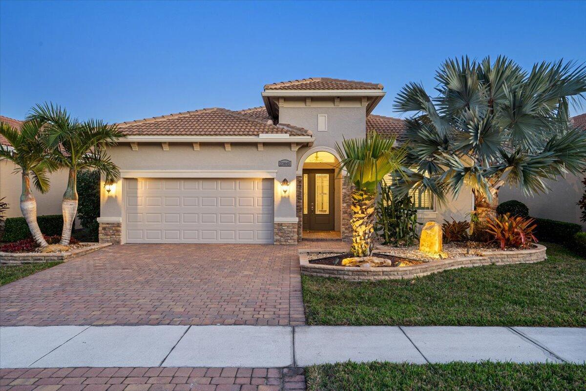 Beautiful ''Lago'' Model at Verano (PGA Village) with Great Curb Appeal exception tropical upgraded landscaping, solar landscape lighting, extended patio 468 sq ft & WONDERFUL LAKE VIEW SETTING! Features CBS Construction, Impact Hurricane Windows & doors, Barrel tile roof, paver driveway, walkway and patio. Hosts 2 BR's, 2 BA's, Den, 2 CG with additional storage & fabulous Great Room. Stunning upgraded Kitchen boasting 42'' cabinets, stainless steel appliances, Blanco Sigranit 33'' Farm sink, double wall ovens, cooktop, microwave, LG island breakfast bar, pantry, granite counter tops & backsplash. Details include Volume Ceilings, tile plank flooring, Plantation Shutters, upgraded lighting & crown molding. Large Laundry Room includes LG Washer & Dryer w/ pedestal draws, sink &​​‌​​​​‌​‌​​​‌‌​​​‌‌‌​​‌​​‌‌​​​​ cabinets.