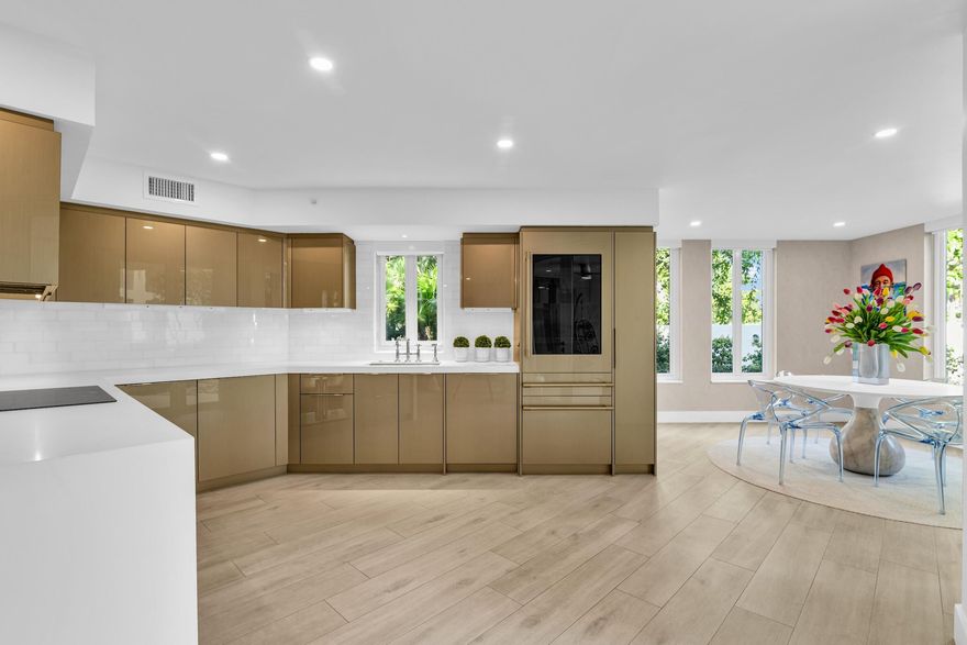 This METICULOUSLY RENOVATED Pet-Friendly, GROUND FLOOR WALK-OUT, 2 Bedroom / 2 Bathroom, 1,706 Sq.Ft. Condo offers the feeling of a private single-family residence with the RESORT STYLE amenities of Mizner Court. Lush greenery surrounds the home, and two covered patios lead directly to the Intracoastal promenade, community pools, and The Boca Raton.

Completed in early 2022, this residence underwent a full-scale reconstruction, taken to the studs with a reimagined open floor plan, raised ceilings, all-new HVAC and ductwork, hurricane-impact glass throughout, upgraded plumbing and electrical, and a whole-unit water filtration system. Every finish and detail was intentionally selected and executed to a refined standard. The kitchen features custom cabinetry by Paris Furnishings, pure white quartz countertops, Carrara marble backsplash, Rohl bridge faucet, GE Monogram French-door oven, induction cooktop, and glass-door refrigerator. A custom dining coffee bar includes a pot filler and integrated pet watering station. The living area includes a wall-mounted 83" LG OLED TV and custom floating cabinetry. The laundry room is fully tailored with California Closets millwork, Electrolux washer/dryer, stainless utility sink, custom Lucite pet crate niche, and full-height decorative tile.

The primary suite includes a sitting area and custom closet, leading to a vanity lounge with floating cabinetry, quartz surfaces, Carrara vessel sink, and accent lighting. The adjoining bath features floor-to-ceiling marble tile, rain shower with herringbone marble flooring, wall-mounted fixtures, and a skirted one-piece toilet. The guest suite/office is accessed via glass French pocket doors, with a second full bath mirroring the same elevated design.

Additional appointments include porcelain wood-plank flooring, Hunter Douglas motorized shades, premium wallcoverings, LED recessed lighting with dimmers, thick quartz surfaces, and Millefiori hand-blown glass pendants.

Mizner Court is a 24/7 staffed, gated, 13-acre waterfront community offering two large heated pools, four spas, Har-Tru tennis, two fitness centers, sauna/steam facilities, marina with guest dockage, EV charging, indoor parking with storage, and on-site professional management. Ideally located near Palmetto Park Road dining, the beach, and Silver Palm Park.