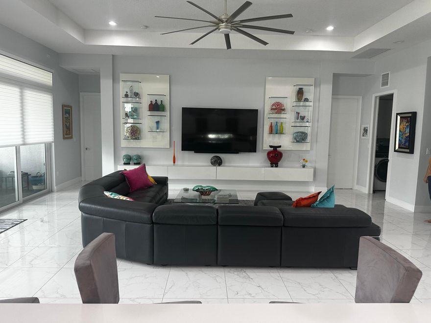 **YOUR SEARCH HAS ENDED** WHY WAIT 1 YEAR FOR YOUR DREAM HOME TO BE BUILT? THIS SPECTACULAR CONTEMPORARY 3 BEDROOM + DEN/OFFICE 3.5 BATH LAKEFRONT HOME IN VALENCIA SOUND, IS IN PRISTINE CONDITION AND WITHIN WALKING DISTANCE TO THE CLUBHOUSE W/RESTAURANT BISTRO  & BAR. THIS HIGHLY UPGRADED EXPANDED JADE MODEL FEATURES A GOURMET KITCHEN W/UPGRADED CABINETS AND TOP END APPLIANCES. IMPACT WINDOWS, SUMMER KITCHEN, WHOLE HOUSE GENERATOR FOR ADDED SAFETY. SITED ON A BEAUTIFUL NORTH/SOUTH FACING LOT. JUST MINUTES FROM THE BEST SHOPPING, DINING AND ENTERTAINMENT W/ACCESS TO I 95 AND THE FLORIDA TPKE. FOR EASY COMMUTE TO THE BUSINESS CENTERS OF WEST PALM BEACH, BROWARD AND MIAMI DADE. ALL INFO, SQ. FOOTAGE AND MEASUREMENTS DEEMED RELIABLE, BUT NOT GUARANTEED BY SELLER, BROKER OR AGENT. A MUST SEE! Welcome to Valencia Sound, a premier luxury lifestyle community designed for those who appreciate elegance, recreation, and vibrant social living. At the heart of the community is an impressive 38,000-square-foot clubhouse, offering an exceptional collection of amenities and gathering spaces that create a true resort-style experience every day.  Residents enjoy a full-service restaurant with both indoor and outdoor seating, perfect for casual lunches, elegant dinners, or socializing with friends and neighbors. The clubhouse also features a poolside bar and a lively sports lounge, providing the ideal setting to relax and unwind.   For entertainment and special events, Valencia Sound boasts a magnificent grand ballroom complete with a dance floor, performance stage, and dressing rooms, making it the perfect venue for live shows, concerts, and community celebrations. Additional social spaces include three dedicated card rooms, a catering kitchen for special events, a cooking studio for culinary demonstrations and classes, and a fully equipped arts and crafts center for creative pursuits.   Health and wellness are a central focus at Valencia Sound. The state-of-the-art fitness center includes a wide range of facilities such as dedicated exercise studios, physical therapy rooms, a ping-pong room, steam rooms, and massage rooms, allowing residents to maintain an active and balanced lifestyle.   Outdoor amenities rival those of a luxury resort. Residents can enjoy a spectacular resort-style pool, a lap pool, a resistance walking pool, a children's pool, relaxing whirlpool spas, and shaded cabanas that provide the perfect place to relax in comfort.   For sports enthusiasts, Valencia Sound offers exceptional facilities including six lighted tennis courts, eleven lighted pickleball courts, and four lighted clay bocce ball courts. A fully stocked tennis pro shop is also available, providing equipment, apparel, and professional support for players of all skill levels.  Valencia Sound offers an extraordinary lifestyle where luxury amenities, active recreation, and a vibrant social atmosphere come together to create one of the most desirable living experiences available.