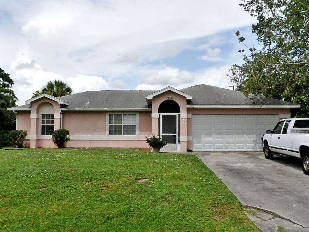 Photo of 317 SW Buxton Avenue, Port Saint Lucie, FL 34983 (MLS # R10952730)