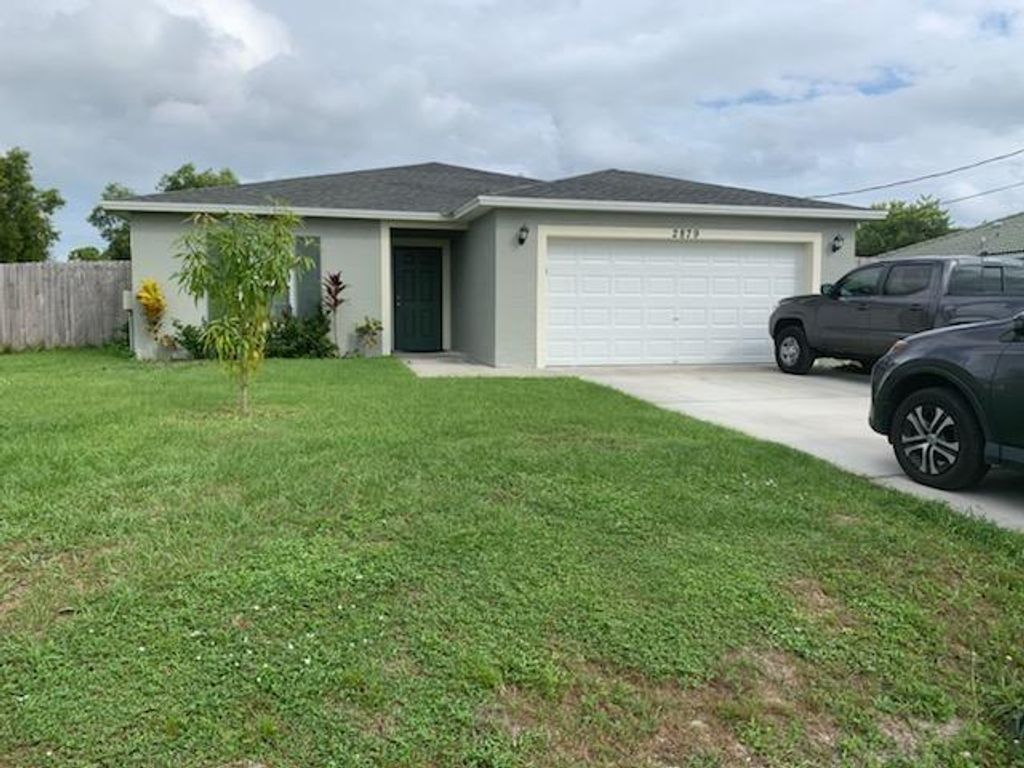 Photo of 2879 SW Ann Arbor Rd, Port Saint Lucie, FL 34953 (MLS # F10328077)