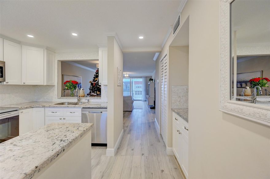 Top floor & turn key, this 2 bed/2 bath condo has been tastefully remodeled from top to bottom, including new kitchen with raised ceilings, mother of pearl backsplash, granite countertops, & stainless appliances. Other features include designer bathrooms, wood-look plank tiling, crown molding, custom closets & dressers, impact windows/doors, and plantation shutters. A/C only 1 year old. Amenities include 24-hr manned security, 2 pools, function room, Tiki huts, billiard/card room, putting green, ping pong table, & fire pit. Close to shopping, fine dining, Greg Norman signature golf course, and the redesigned Pompano Pier!  This waterfront community provides ocean access via Hillsboro Inlet or Port Everglades, and dockage can be rented or purchased upon availability. All furniture included!