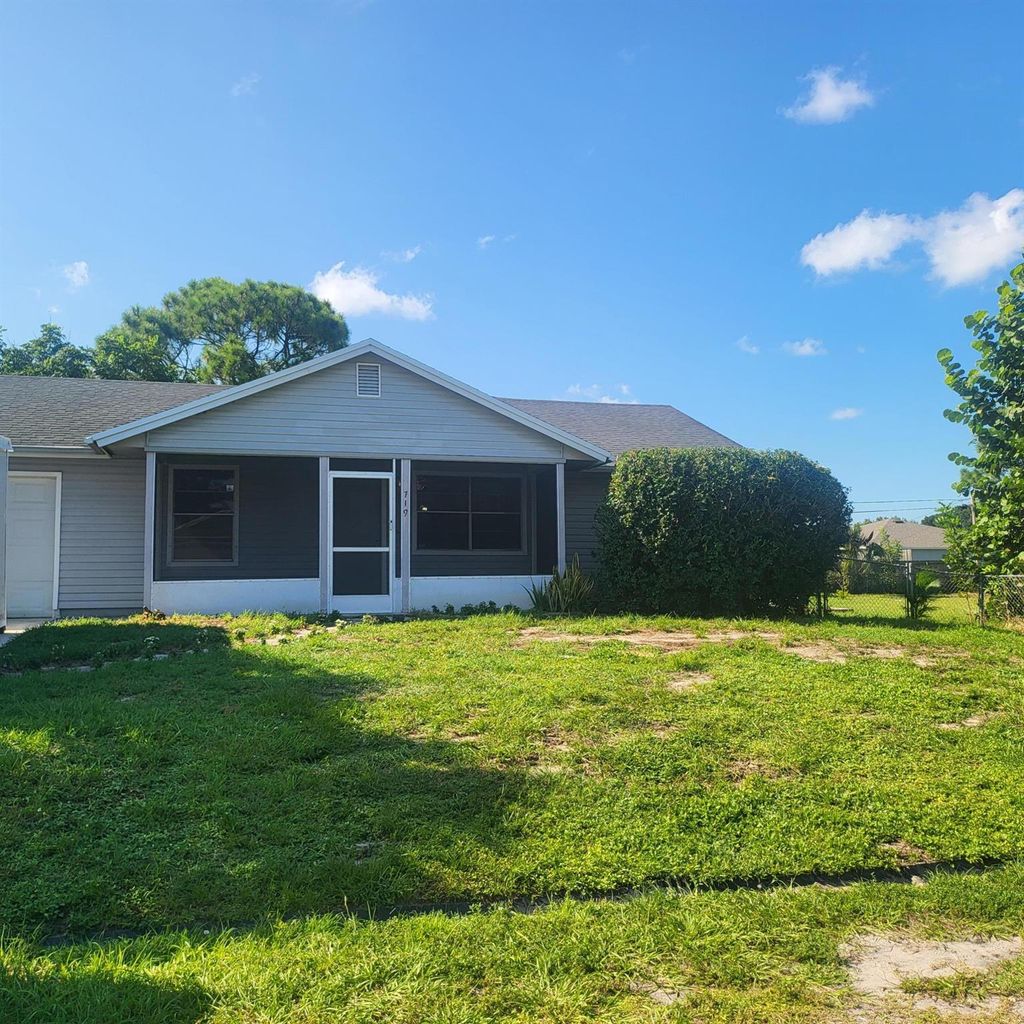 Photo of 719 SW Arkansas Terrace, Port Saint Lucie, FL 34953 (MLS # R11013499)