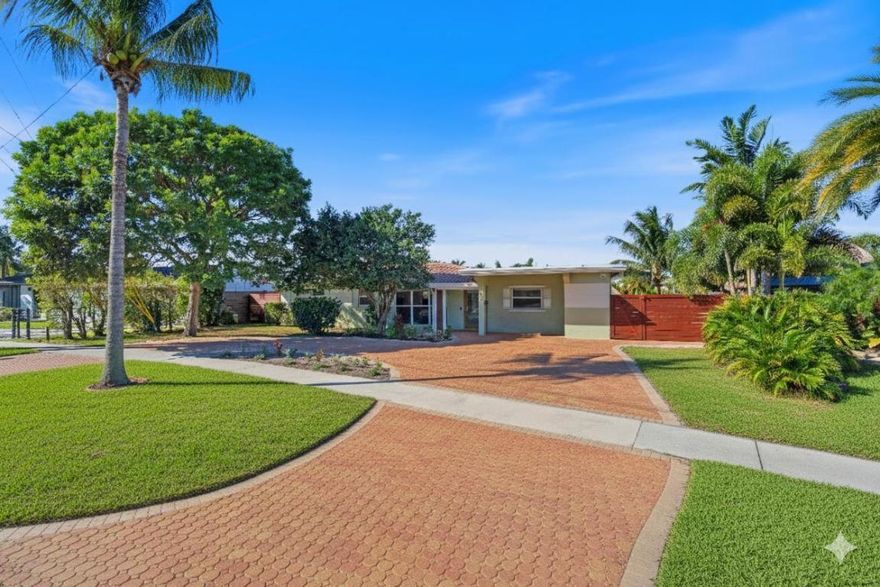 100 feet of waterfrontage property with 30' dock.  3 bedroom, 2 bath waterfront  home in Cypress Harbor on an oversized lot that widens towards the water with views of multiple canals. Intracoastal access, one house down from recently raised 5th Avenue bridge. Tile/wood flooring throughout, updated kitchen with newer stainless steel appliances, including gas range. Gas tankless hot water heater and gas dryer. Newer paver circular drive, with paver walkways winding down through the backyard to a lighted patio overlooking canal.    Oversized fenced yard, shed/she-shed, screened patio with separate laundry room. Quiet neighborhood with convenient access to Pompano Beach's growing list of amenities.