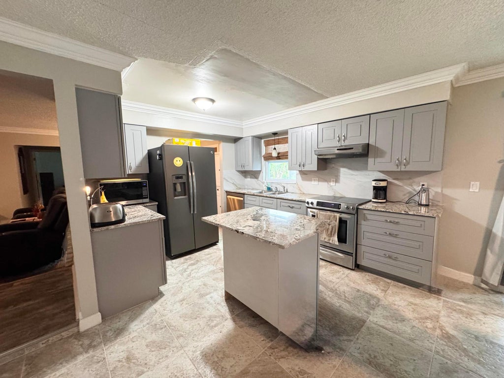 Photo of 443 SE Langfield Avenue, Port Saint Lucie, FL 34984 (MLS # B26031541)