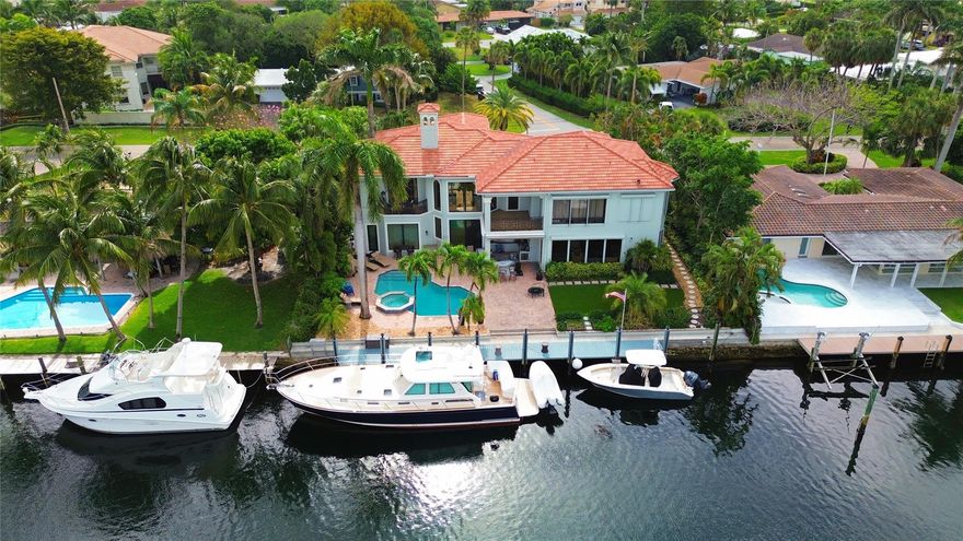 Discover this exceptional 4-bedroom, 4.5-bathroom estate located on one of Lighthouse Point’s most desirable streets, just minutes from the Hillsboro Inlet. Set on an expansive 11,000 SF lot this home is a boater’s dream with 100 feet of deepwater frontage, offering quick, bridge-free access to the ocean. With over 4,500 square feet of living space, the home features soaring ceilings, generously sized ensuite bedrooms that provide both comfort and privacy, partial high impact windows and doors, an expansive pool deck with a summer kitchen, + a newly turfed area. Enjoy the Florida lifestyle to the fullest with a backyard that invites relaxation and recreation, complete with panoramic water views. The location is unmatched, just a 5 minute walk to Port 32 Marina & Nauti Dawg restaurant.