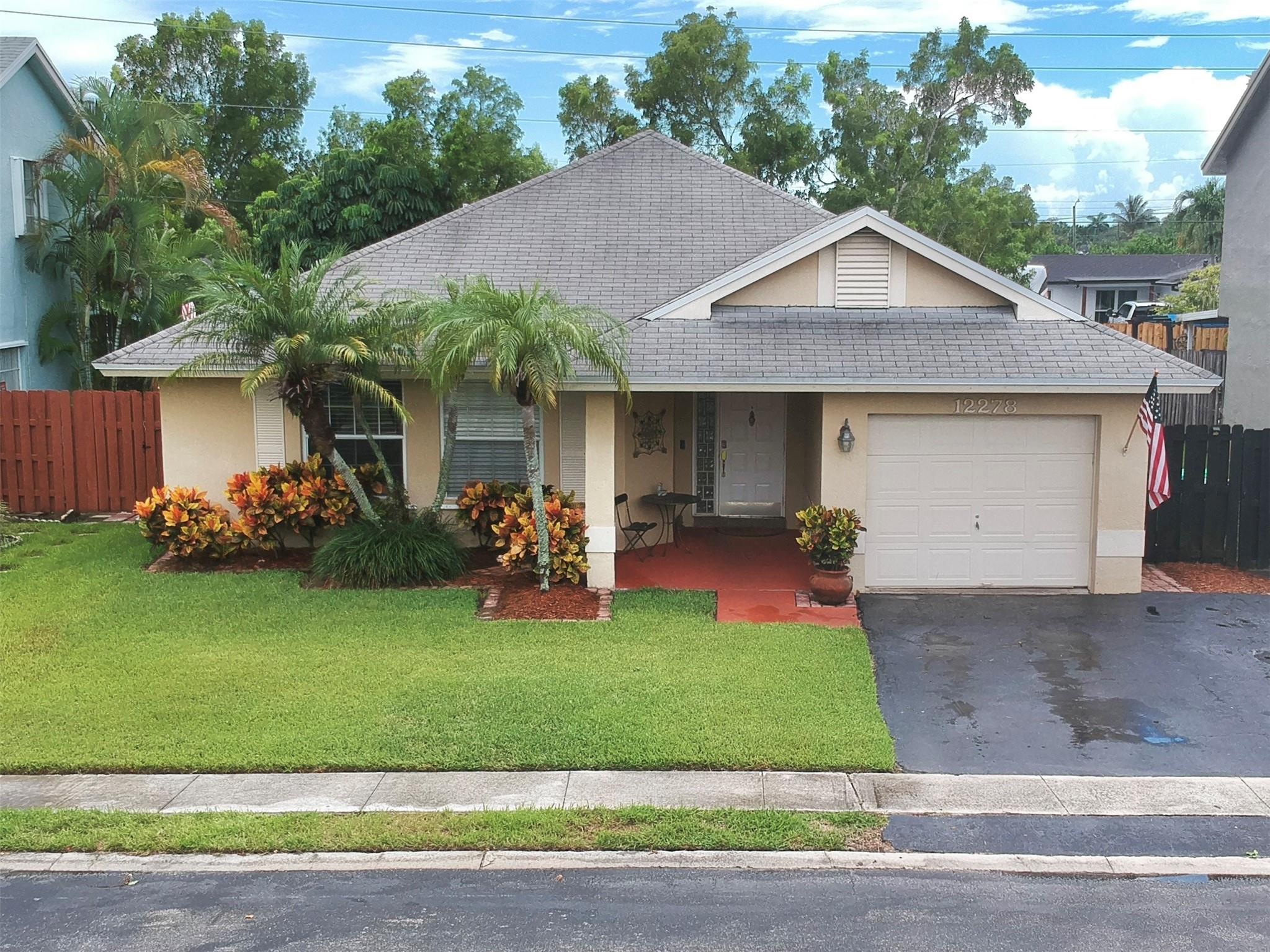 COMING SOON! Handsome 3/2 in well established neighborhood in Sunrise, FL. Located near the Sawgrass Mills mall with easy access to the Sawgrass Expressway. This home sports a large, open family room and a cozy kitchen with a gas range. The primary bedroom is spacious and features a large walk in closet and a private bath with dual vanities and a walk in shower. The one car garage is packed with potential and the large back yard includes a covered patio and a raised wood deck. This property is part of the Sawgrass Estates community where residents have access to the community pool, hot tub and 4 hole putting green. Showings begin Monday, 8/25/25.