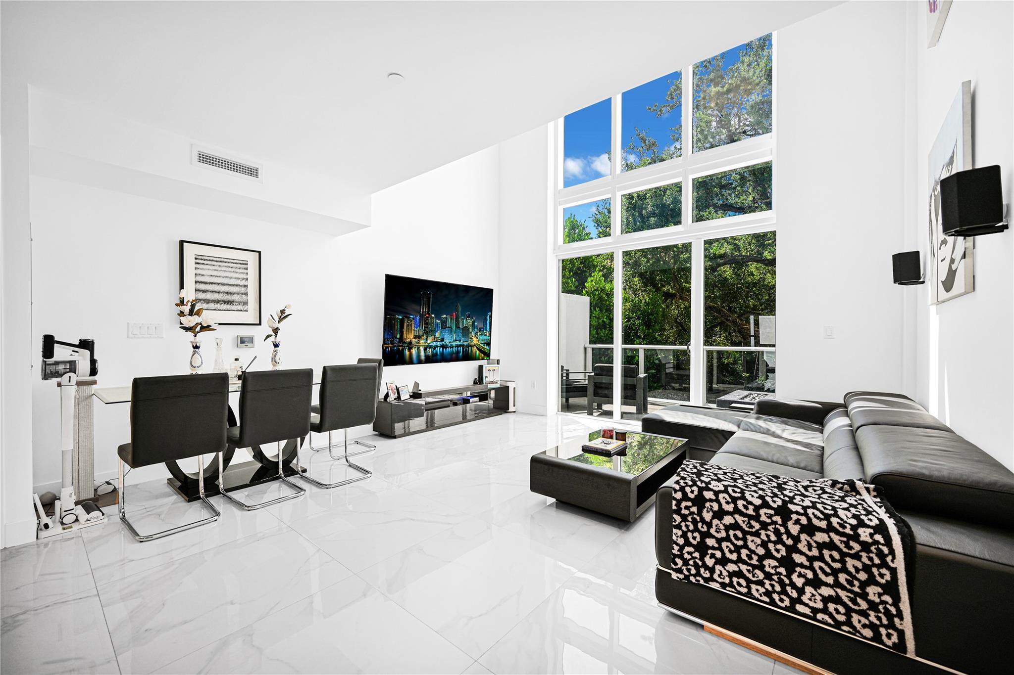 Experience the pinnacle of modern living in this stunning 2-bed plus den, 2-bath townhouse, set within a secure, gated community across from Miami’s renowned Design District. Soaring double-height ceilings and a sleek, contemporary design creates an ideal space for both relaxation and entertaining. A generous 692-square-foot rooftop terrace comes equipped w/ full plumbing and lush turf, perfect for soaking in the sun, hosting get-togethers, or enjoying the vibrant skyline views. An additional 193-square-foot terrace provides a tranquil outdoor retreat for morning coffee or al fresco dining. For added convenience, the property includes a 264 sqft garage and an extra assigned parking spot located just steps from your door. The Design District, Midtown, and Wynwood are only minutes away.