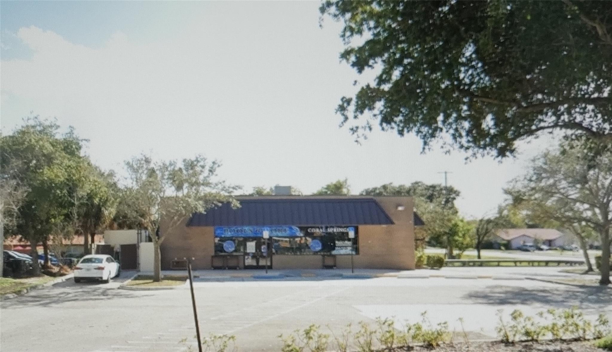 Corner Lot with 30,000 square feet. Access for 110 Avenue and Wiles Road. 50,000 cars per day and good visibility from E & W lanes on Wiles.