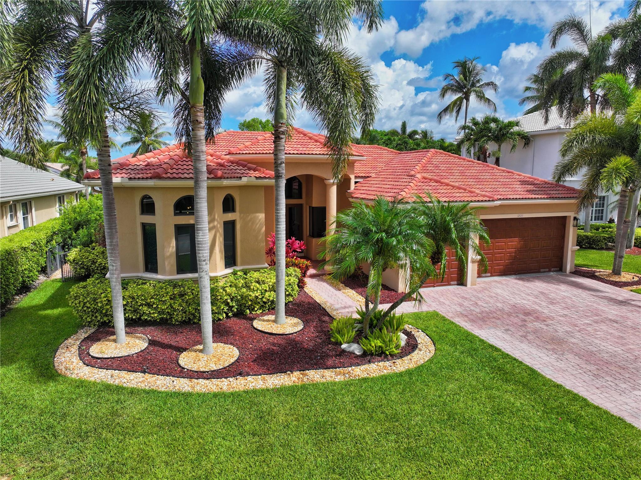 Finally, the One you have been waiting for! Beautiful Waterfront Home, fully upgraded w/ Bronze Frame Impact Windows / Doors. Stunning Designer Finishes w/ Perfect triple split floorplan, wonderful Italian Tile. Formal Dining & Living Rooms w/ Electric Fireplace. Volume Ceilings w/ Recessed Lighting. Designer Kitchen has wonderful Layout,Quartz w/Waterfall,Breakfast Table Area plus Counter Seating. 2 Huge Bedrooms w/ Jack-Jill Bath, 2 Big rear Bedrooms w/Lake View / Cabana Bath. Beautiful Wood Tile in Bedrooms adds warmth and style. Custom Closets throughout. Elegant Master Retreat w/ luxurious Bath. Expansive Pool Patio, Sparkling Salt water Pool w/ Sundeck, Full Summer Kitchen, 2 Sunbrella Power awnings, Fenced Turf Yard, Lake Access for sm Boat, Paddleboards, Kayaks... A Wonderful Home!