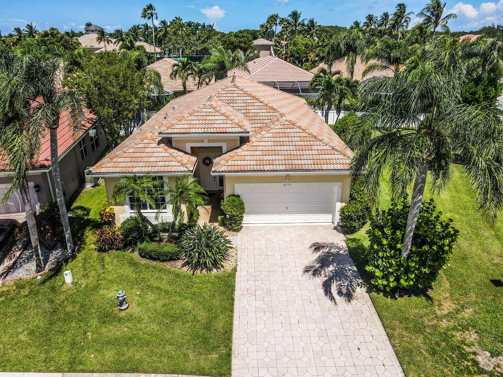 Pristine Single-family home in the centrally located gated community of Andros Isle in the prestigious West Palm Beach. The home is a 3/2/2 with the 3rd bedroom used as a home office. It's located on an extra wide, .21 acre corner lot, which allows for plenty of space for a pool or garden.Home features: Hurricane impact windows and doors, Bahama Shutters, Corian counter-tops in kitchen; 50-gal electric water heater, 2 Bose speakers in living room with wiring included; pocket doors, ceramic tiles in living areas; soaring ceilings; chair rail and crown molding, dimmer light switches, electric fireplace, central vac, Jacuzzi tub in master bath, his/her huge walk-in closets in master bedroom suite; full house water filtration system. Centrally located to all shopping & dining venues,