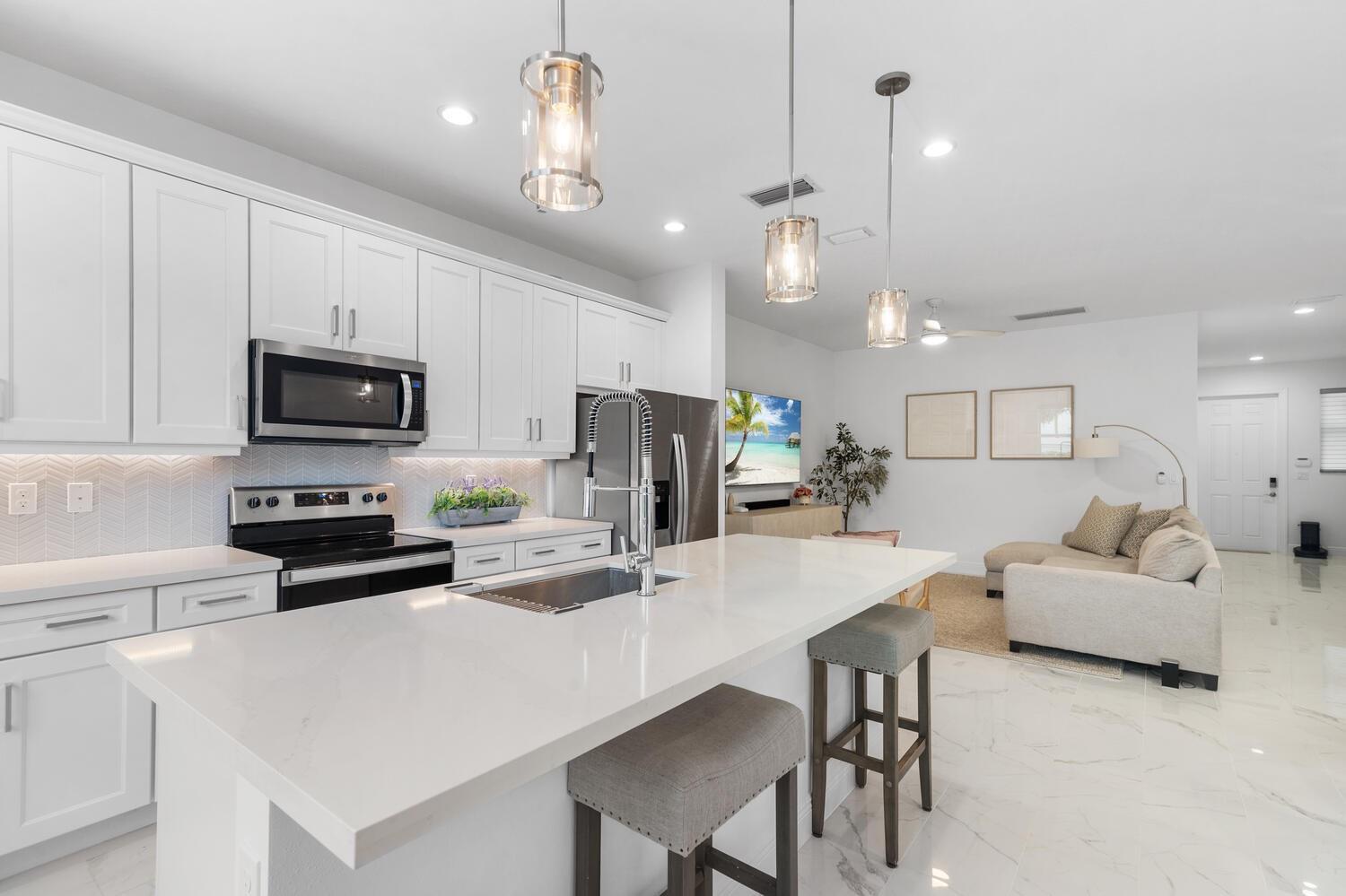 BRAND NEW! 3-bedroom, 2.5-bath townhome in a gated Deerfield Beach community, just 15 minutes from the beach! This move-in ready home features an open layout, modern finishes, and an updated kitchen with quartz counters, stainless steel appliances, and a large island with bar seating. Upstairs offers three bedrooms, two stylish bathrooms, and in-unit laundry. Enjoy two assigned parking spots and included cable. Pet-friendly and ideally located near I-95, shopping, dining, and top schools. A perfect blend of comfort and convenience. With a community pool and gym this place has everything you need! Tenant occupied until August. Yearly lease
