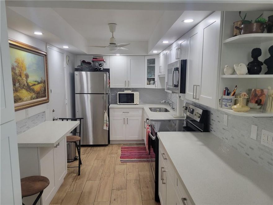 This gorgeous corner unit features 2 bedrooms and 2 full bathrooms, located in a very quiet and well maintained community, walking distance to shopping centers and all mode of transportation, East of I-95, 2 miles from  the beach. Kitchen has been completely remodeled with custom made cabinet, pantry and side board, granite top, and ornamented ceiling, New custom made cabinets in bathrooms and updated showers. windows and sliding doors have been updated recently to Impact glass, Air conditioning as well as water heater are 4 years old. unit overlook the garden thru updated screened porch. Ready to move in.