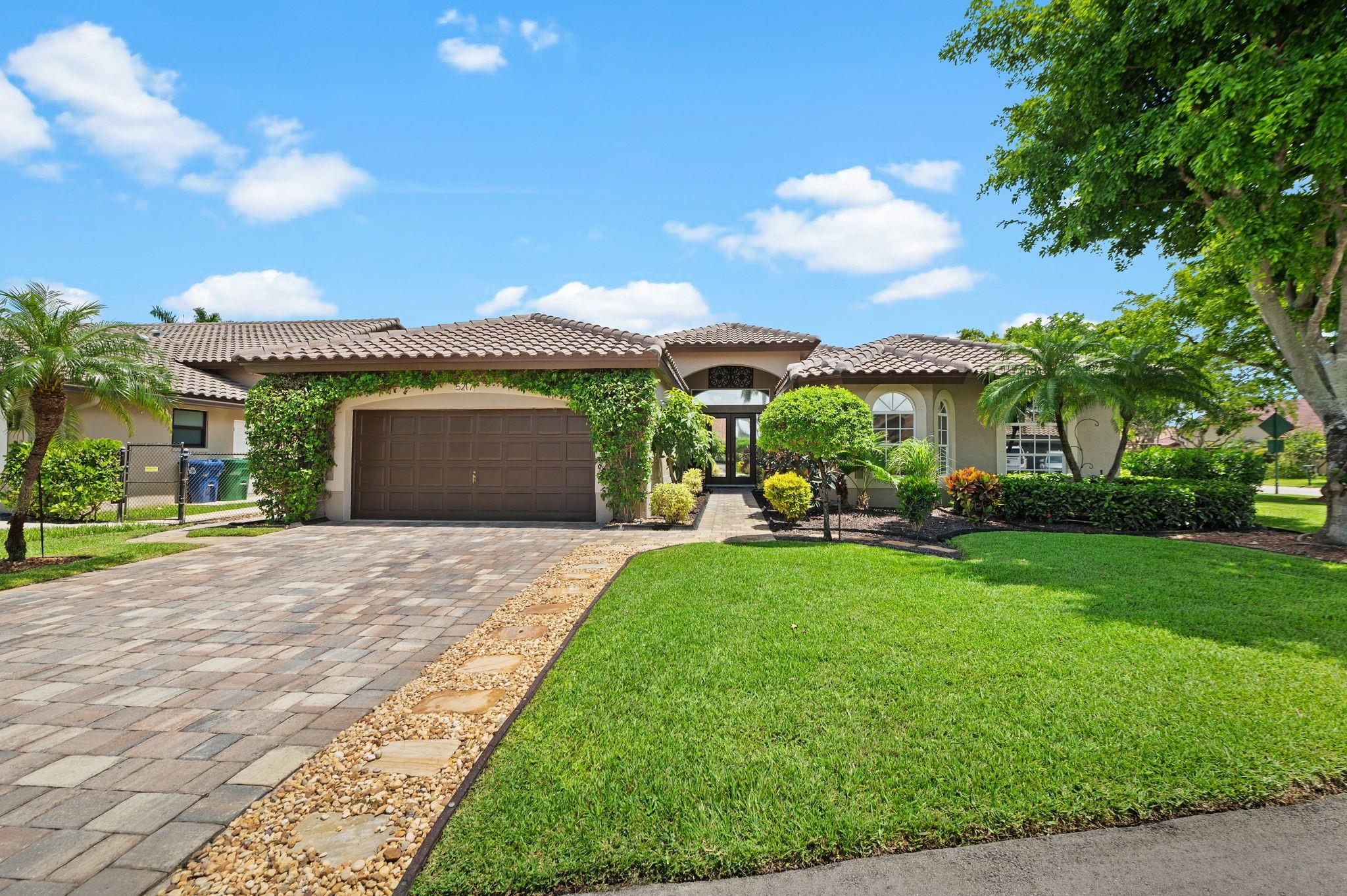 Located on an OVERSIZED CORNER LOT WITH NO SIDE NEIGHBORS in Kensington Commons. NEW ROOF 2024! Features 5 FULL BEDROOMS & 2.5 BATHS. Vaulted Ceilings, OPEN FLOOR PLAN & SPLIT BEDROOMS. Kitchen with wood cabinets, granite counters & stainless steel appliances. Neutral tiled floors in living areas & wood in all bedrooms. NO CARPET HERE. Primary bedroom with oversized walk-in closet & beautifully updated bath with soaking tub, dual sinks & frameless shower. FRESHLY PAINTED INTERIOR & EXTERIOR. Completely FENCED YARD, SALT WATER POOL, front & back lushly landscaped, PAVERED DRIVEWAY, PATIO & WALKWAYS around fire pit make this a tropical oasis. 2 Zone AC's replaced 2019. ALL IMPACT SLIDERS & Shutters throughout. Close to schools, parks, shopping, & restaurants. LOW HOA & NO APPROVAL PROCESS!!