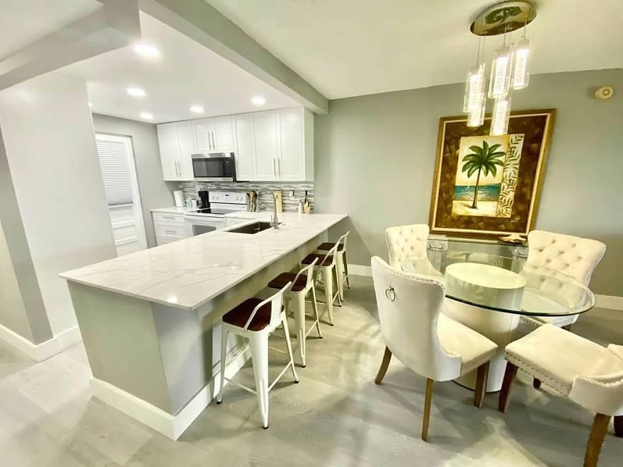 YOU WILL FALL IN LOVE WITH THIS SIMPLY GORGEOUS COMPLETELY RENOVATED UNIT -- NEW OPEN KITCHEN WITH STAINLESS APPLIANCES AND QUARTZ COUNTERTOPS -- NEW VINYL/WOOD FLOORING THROUGHOUT -- FRESHLY PAINTED -- DEN HAS BEEN CONVERTED TO GUEST BEDROOM/OFFICE WITH CLOSET, DOOR TO PATIO AND A STATE OF THE ART GLASS BARN DOOR -- NEW REMODELED BATHS -- ENJOY YOUR EVENING APERITIF ON THE LANAI WATCHING THE SPECTACULAR SUNSETS -- TASTEFULLY FURNISHED --POOL DECK AND BARBECUE VIEW FROM BALCONY -- BIKE TO BEACH -- MINUTES TO MIZNER PARK AND TRENDY DOWNTOWN DELRAY