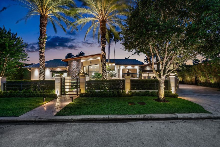 Welcome to an unparalleled paradise in Coral Ridge, where luxury meets waterfront living. This boater's dream home, designed by the award-winning Kevin Akey in 2014 and meticulously reconstructed in 2016, sits majestically on a 12,500 sq. ft. lot with 100 ft. of pristine water frontage. The exterior is a testament to sophisticated elegance, featuring a harmonious blend of stone and metal accents, crowned by a bespoke front door. Step inside to discover a world of opulence with porcelain floors that flow seamlessly throughout the living spaces, complemented by rich hardwood in the serene bedrooms. The home is adorned with imported Italian cabinets and bespoke built-ins, showcasing an exquisite level of craftsmanship. Soaring vaulted ceilings in every room amplify the sense of grandeur and