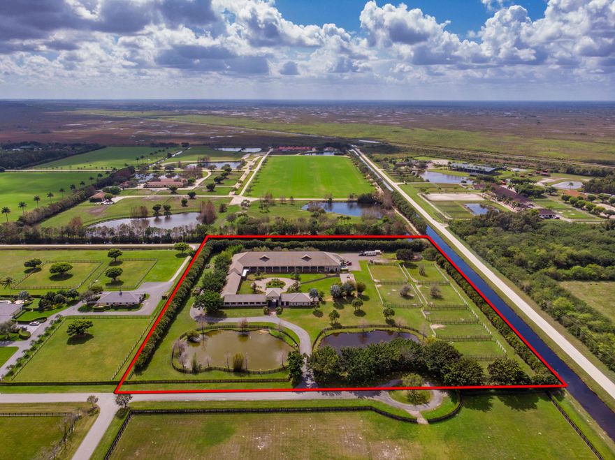 One of the finest established equestrian properties in Wellington - Two Swans Farm is offered exclusively for sale with well-built architecture and designed by one of Wellington's finest - Five Star Builders.  This gated equestrian property has first class riding facilities and amenities for your equine athletes. Property consists of an 80' x 220' indoor riding arena, a 12-stall courtyard style barn, 3 grooming stalls, 2 tack rooms, 2 storage feed rooms and a large storage building attached to the rear of the indoor arena. There is a luxurious 2 bedroom owner's apartment and 3 fully sized groom's quarters with spacious living areas. There are also 8 full-sized four board paddocks for your horses! In case of a storm, the farm is fully equipped with an 80 KBW generator, which will power both the farm and all living quarters. Two Swans farm has it all and is located in the equestrian community, Oak Estate Farm!