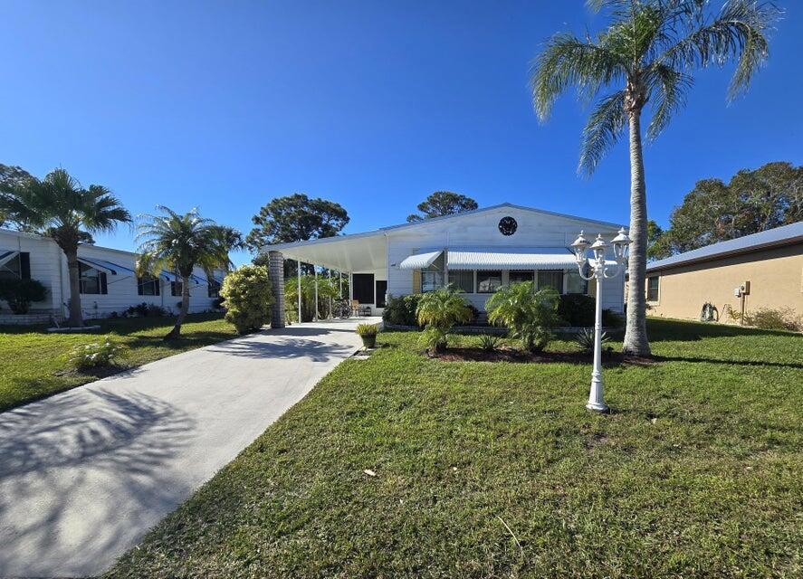 Discover this fully furnished home on the 8th Green, offering stunning golf course views and a lifestyle of comfort and leisure in the 55+ Spanish Lakes Country Club Community Spacious enclosed Florida room with durable vinyl windows, new furniture, & breathtaking views. New metal roof installed 1 year ago with transferrable warranty. Open island kitchen with breakfast bar, ideal for entertaining. Beautifully furnished living room with three sleeper sofas, perfect for extended family or guests. Large primary bedroom with oversized closet, ensuite featuring a sunken tub and separate double shower. Private guest bedroom and bath. Separate TV room, covered carport with extra tie-downs, and back patio overlooking the private golf course. Monthly Land Lease fee covers Private golf course,