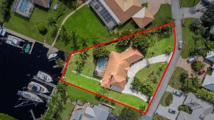 Beautifully renovated waterfront home in Beau Rivage with ocean access. This spacious 4-bedroom, 3-bath residence features two master suites, updated kitchen and baths, and stunning 36''x24'' tile flooring throughout. Enjoy open living spaces that flow seamlessly to the private screened-in pool and patio, perfect for entertaining or relaxing by the water. Storm protection includes a combination of accordion shutters and impact features for peace of mind. Nestled in a quiet community with an HOA of only $100 per year, covering lawn care in the medians. The community is in the process of upgrading to city water and city sewer. Move-in ready and just minutes from the ocean by boat, Florida waterfront living at its finest!