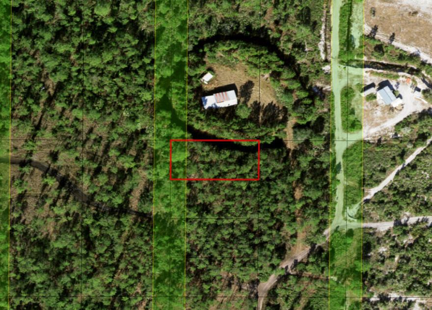 Owner Financing available on this Holopaw lot. Great campsite.