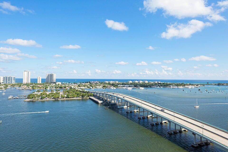 Step into this stunning 3-bedroom, 3-bathroom residence and prepare to be captivated by multimillion-dollar views of the Atlantic Ocean, Intracoastal Waterway, tranquil parklands, and the iconic Singer Island skyline. From sunrise to sunset, natural light pours into every room, enhancing the home's sophisticated ambiance. This open-concept floor plan seamlessly blends style and comfort, featuring neutral tones with warm, inviting accents--designed to impress even the most discerning buyers. Whether entertaining or relaxing, you'll appreciate the seamless flow of space and the high-end finishes throughout. Ideal for avid boaters, divers, snorkelers, runners, and cyclists, this location is a true paradise for outdoor enthusiasts. Don't miss your chance to own a piece of paradise.