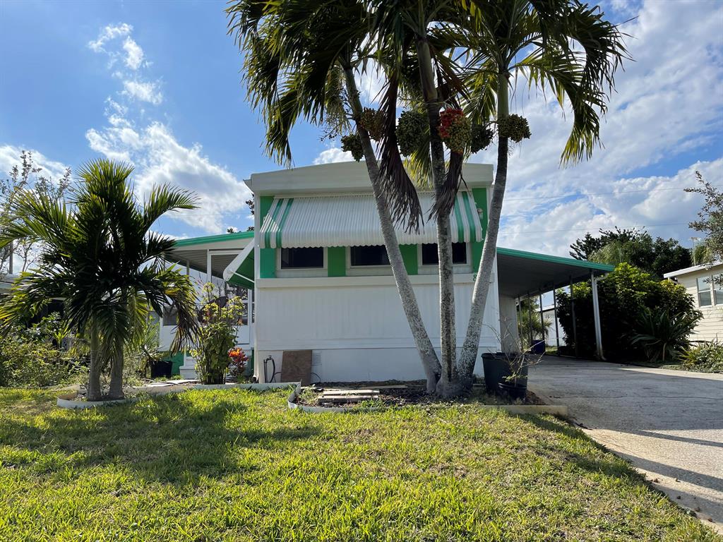 It's the beach life! Bring your boat! You own the land, optional pool/clubhouse for just $300 p/year. Close to the boat ramp, Hobe Sound Beach, Manatee Pocket restaurants & shops, downtown Hobe Sound with it's posh shops & restaurants & you can walk to the grocery store. A diamond in the rough, featuring the desired split floor plan, 2 bedrooms with 2 full remodeled bathrooms, the kitchen remodel has been partially finished with new cabinets, countertops and backsplash, with materials left to finish, no soft spots in floor. This home will need your handy touch to paint, finish kitchen and add your flooring. There is a nice screened in concrete porch to enjoy the tropical breezes. It's time to have your own place to pull your car in under the carport, have a shed for tools and to bbq!