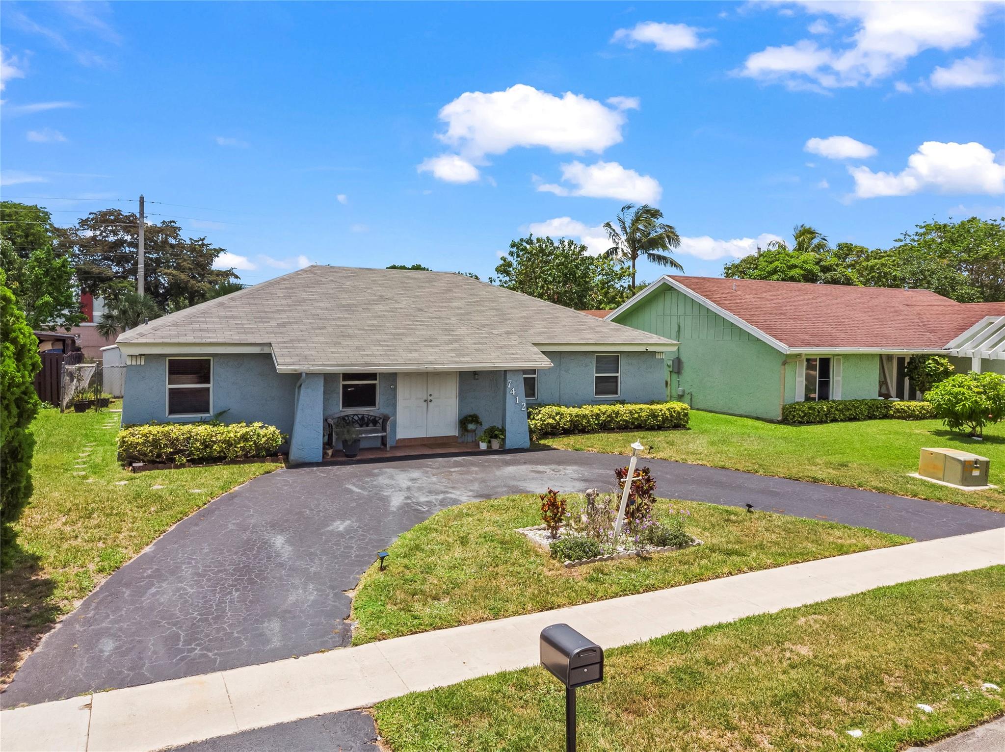 Nicely updated 4 bed, 3 bath single-family home with a permitted addition creating a 2nd master/in-law suite featuring a walk-in closet and private bath. The kitchen has been expanded and remodeled with wood cabinets, granite countertops, a center island, stainless steel appliances, and a built-in standalone freezer. Impact windows and doors throughout. Spacious living and family rooms. Circular driveway. Large backyard with storage shed, room for a pool, and canal views.