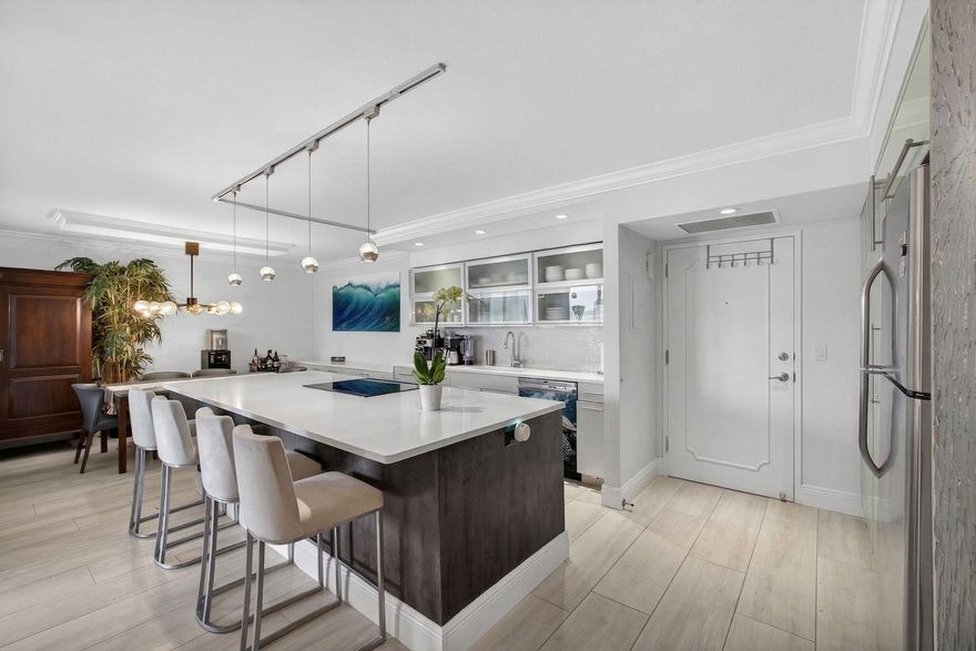 Paradise living on Singer Island! This beautifully updated residence at the Aquarius offers breathtaking ocean and Intracoastal views from every room. Designed with an open, airy layout, the living and dining areas flow seamlessly into a stunning kitchen featuring white quartz countertops, a spacious eat-in island, soft-close cabinetry, and stainless steel appliances—perfect for both everyday living and entertaining.  Both bathrooms have been tastefully renovated with elegant white quartz finishes, while crown molding throughout adds a refined touch. Wake up to spectacular ocean views from the primary suite and unwind on your private balcony overlooking both the Atlantic and Intracoastal waterways.  Aquarius amenities include a newly renovated fitness center, sauna, billiards room,  community lounge, library, resort-style pool, and private beach access—offering the ultimate in coastal living.