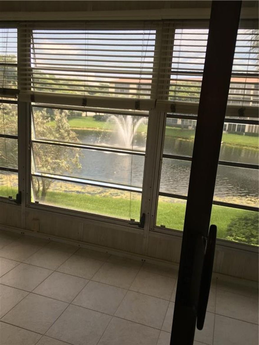 WONDERFUL WATER VIEW FROM THIS GLASS ENCLOSED PATIO OF THIS LOVELY 2/2 CONDO. ENJOY THE SUNSETS WHILE SIPPING A GLASS OF WINE & ENJOYING YOUR VIEW. NO WALPAPER, OR MIRRORS OR CARPET TO REMOVE. BEAUTIFUL LAMINATE FLOORING IN ALL THE ROOMS EXCEPT KITCHEN & BATHROOMS, NICELY TILED. CONDO IS ON THE SECOND FLOOR NEAR CENTER STAIRCASE FOR EASY ACCESS IN CASE YOU DO NOT WANT TO TAKE THE ELEVATOR.  EASY TO WALK UP OR DOWN. COUNTRY CLUB LIFE STYLE WITH FREE BUSES, RESTAURANT ON SITE, GOLF, TENNIS, & THEATER ETC..