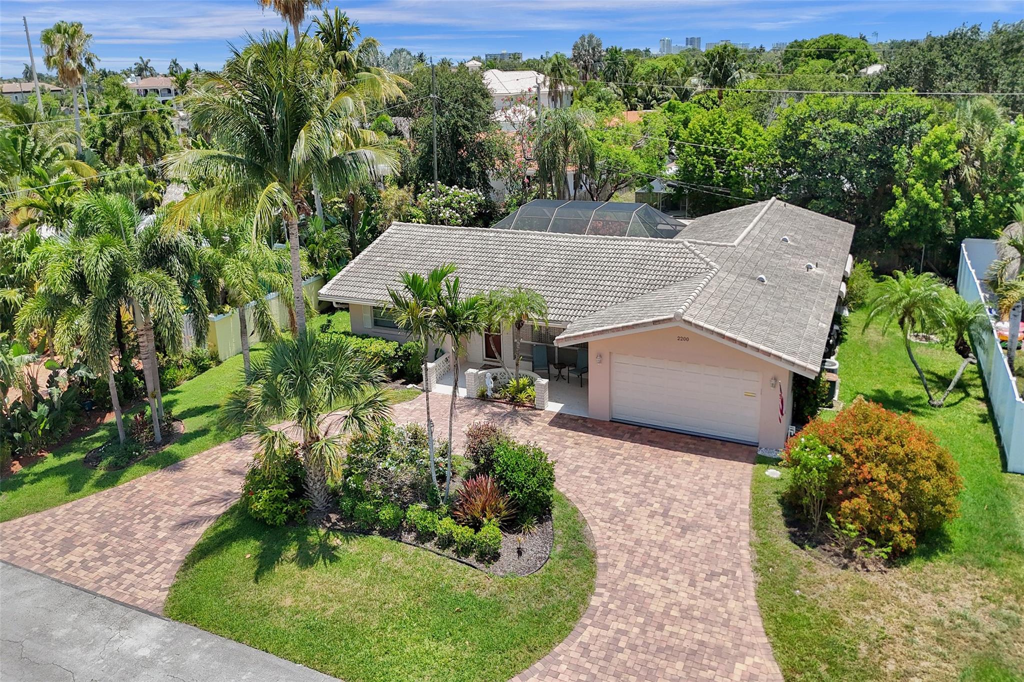 Enjoy ideal southern exposure on a highly sought-after street south of Sample Road in Lighthouse Point. This lovingly maintained original home features 3 bedrooms, 2 bathrooms, a split-bedroom layout, spacious living and dining areas, and a convenient cabana bath. The backyard is perfect for entertaining, offering a large screened-in pool and patio, along with a tranquil area for gardening. A two-car garage completes this charming residence with plenty of potential.