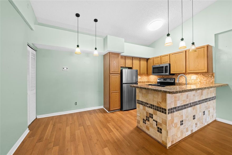 Spacious 2 bedroom, 2 bathroom condo located on the second floor in the well maintained community of Coco Parc Condo. This community welcomes all ages. Open floor plan with vaulted ceilings, updated kitchen with granite counters and stainless steel appliances. Updated bathrooms with Kohler fixtures. Laminate and tile flooring throughout, no carpet. Full size washer/dryer in the unit. Expanded screened in balcony (newer screens) with access to the bedroom and living room. Per association: pets are welcomed.