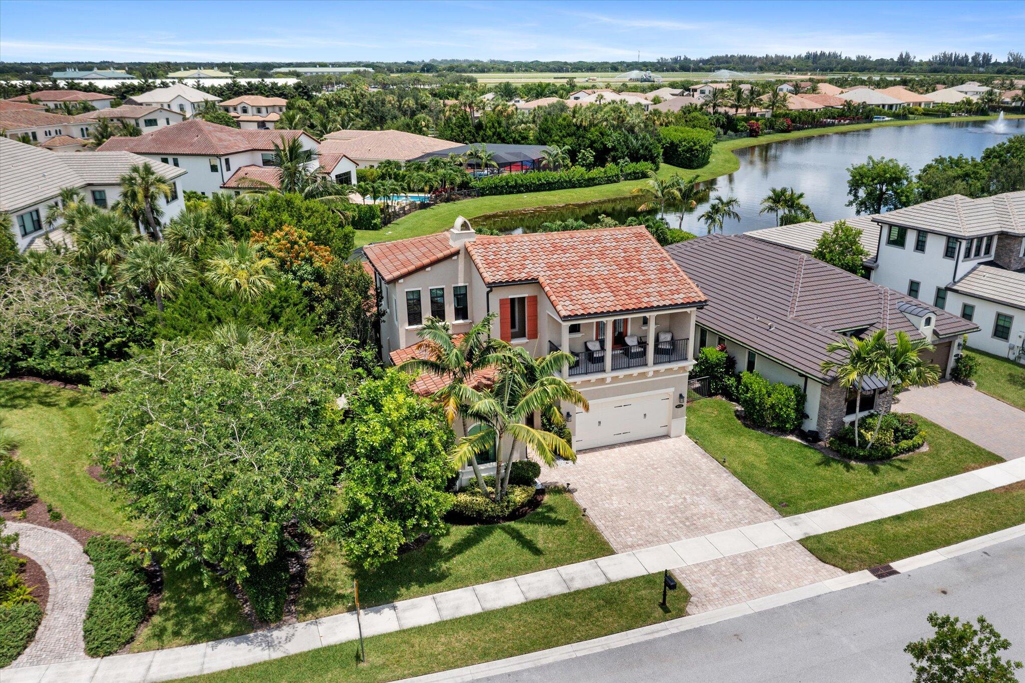 Luxurious Lakeside Living Meets Equestrian Elegance | Surrounded by Verdant stables, Racetrack & minutes to Wellington Equestrian Center | Over $25K in designer upgrades | Premium corner lot w/ panoramic lake views | Complete hurricane impact windows & doors | Soaring ceilings w/ crown molding, custom accent walls & Designer Lighting | Gorgeous Kitchen | Quartz Counters, High-end stainless steel appliances & Island | Spacious primary suite w/ walk-in closets | Ensuite bath features soaking tub, frameless rain shower & separate vanities | Two guest suites w/ private baths -- one w/ private balcony | Marble travertine screened patio w/ outdoor kitchen | Resort-style amenities: clubhouse, pool + spa, fitness center, indoor sports court, pickleball, tennis, splash zone & more.