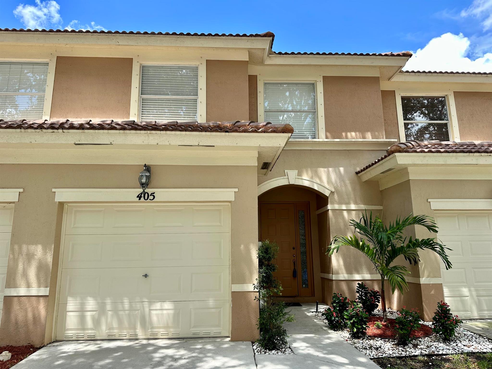 Luxurious and updated town home in Royal Palm Beach in the gated community of Seminole Estates. 3 Bedrooms, 2 and 1/2 bathrooms. Spacious and open floor plan with modern kitchen with granite counters, stainless steel appliances, smooth gray cabinets and upscale lighting. Ceiling fans throughout. Bathrooms have been updated for a modern, clean style. The master bathroom features a stand alone soaking porcelain tub, dual vanities with beautiful cabinetry and stand alone shower. Fresh neutral gray and white paint theme. Vinyl flooring. Sliding glass doors open to a screened in back patio with privacy wall for relaxing. The community offers residents a range of amenities, including a sparkling swimming pool, a well-equipped fitness center, and beautifully landscaped walking paths.