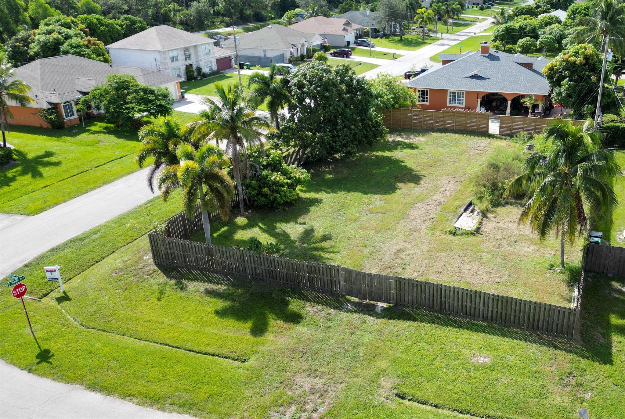 Beautiful Oversized, Fenced in, Corner Homesite in the popular SW section of Port St Lucie. Measuring approx. 95'x125'. Culvert pipe for Driveway has been installed for easy access onto lot. Only minutes to FL's Turnpike, Publix Shopping, Schools, Restaurants and the all New Florida Coast Medical Center. This Healthcare Facility is a state-of-the-art healthcare center, set to open in September 2025! Fruit Trees including Mango Trees that are already producing juicy mangos! There are not many vacant homesites left in this highly sought after area of Port St Lucie! Call today!