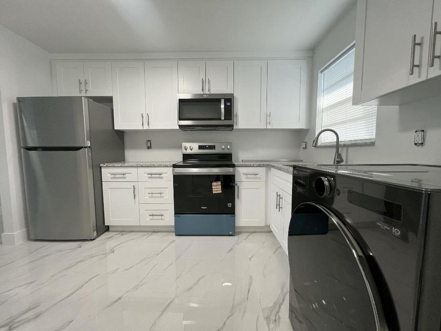 1 WEEK OR LESS APPROVAL - Beautifully remodeled 2-bedroom, 2-bath condo offering a bright, modern living experience. This residence features marble flooring throughout, a brand-new kitchen with new stainless steel appliances, plus a new washer/dryer combo. Freshly painted with updated finishes, creating a clean, fresh feel. Split bedroom layout with spacious living and dining areas, ample closet space, and a screened balcony. Assigned parking, guest parking, and elevator access in the building. Conveniently located near shopping, dining, and major roadways.