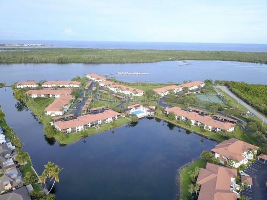 Welcome to Hanson's Landing. This is the most sought out building in the community. Rare 2 BR with a Den is on the Peninsula overlooking the Intracoastal Waterway and St. Lucie Inlet State Park/ National wild life refuge. Unbelievable views from the moment you walk in the front door. Other features include Vaulted ceiling with Exposed Rafters in the living room, walk-in closet, skylight in the master bathroom, Eat-in kitchen with Intracoastal view, Full size Washer and Dryer, Wet bar. This is an End unit, so you will find many windows with georgeous views. Partial hurricane shutters. Enclosed large porch, outside storage, 1 assigned carport and extra parking available. 1 small pet under 25 lbs is welcomed!
