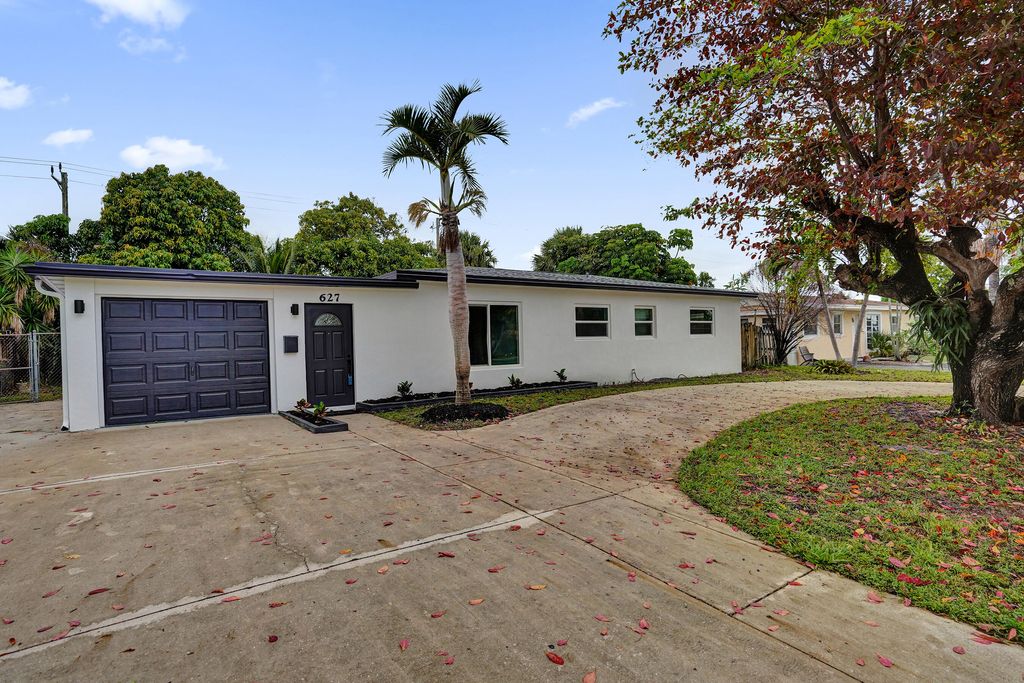 Photo of 627 W Ilex Drive, Lake Park, FL 33403 (MLS # B26024840)