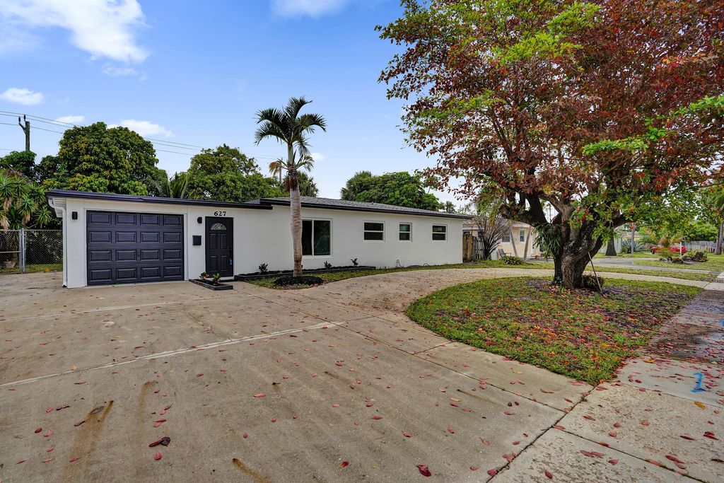 Photo of 627 W Ilex Drive, Lake Park, FL 33403 (MLS # B26024840)