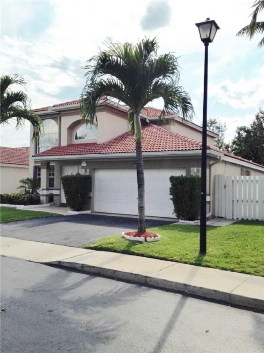 Gorgeous updated 3 bedroom, 2.5 bathroom, 2-car garage home in The Point, inside of desirable Residences of Sawgrass Mills. Many upgrades to include accordion window shutters, wood floors, travertine tile (in guest bathroom), granite countertops and backsplash, and updated kitchen cabinets.  Large screened back patio overlooking the water with a hot tub.  Mango and avocado trees in back yard.  Walk or jog to Flamingo Park.  Low HOA fees.