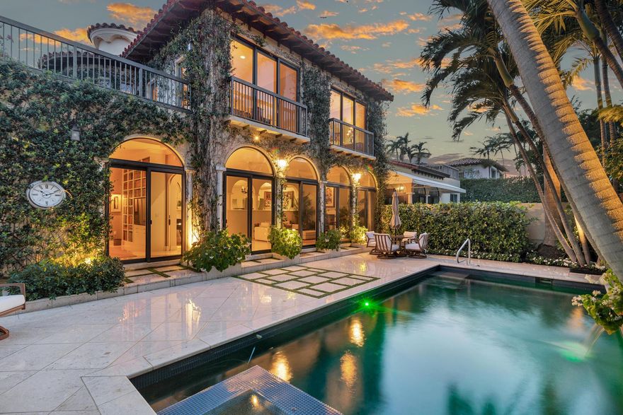 This Italianate 3 bedroom, 3.5 bath townhome offers over 4,100 square feet of refined Palm Beach living. Enjoy a sunlit courtyard, private pool and jacuzzi set amongst tropical landscaping. Thoughtful architectural details allow the interiors to be filled with light. Highlights include tall ceilings, an elevator, designer powder room, first floor guest suite with full bath, library (optional third bedroom + full bath), and a well-appointed butler's pantry and bar, full impact windows & doors, full-house generator, and air-conditioned two-car garage. The entire upper level is devoted to a private primary suite with two closets, sitting room, expansive bath and outdoor terrace. Residents enjoy exclusive access to L'Ermitage's private lakefront pool and clay tennis courts.