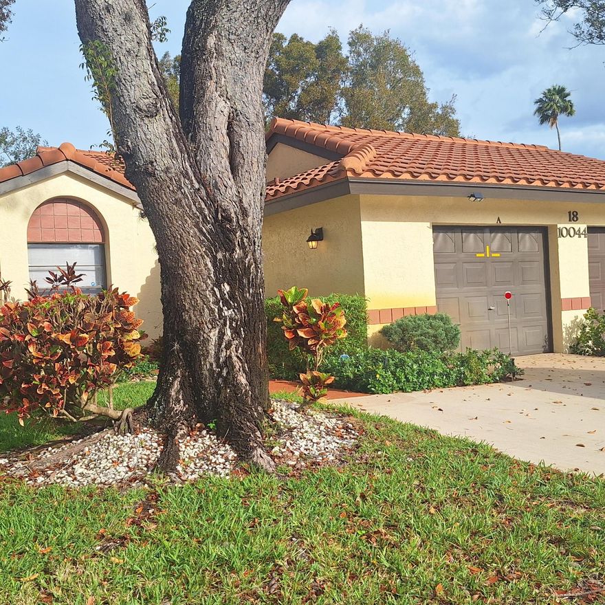 Spacious villa with 2 bedrooms, 2 full bathrooms and a den available in sought after PCL!   This villa boasts vaulted ceilings, skylights and many upgrades including; custom built-in bureaus in the primary bedroom, bookshelves in the den and a walk-in California Closet.  The kitchen features granite counters, custom cabinets with pull-out drawers, two sinks and an opening to the dining room.  Ceiling fans and tiled flooring throughout.  The spacious living room leads to a huge lanai that faces  private back yard greenery.  This home is impeccably maintained by snowbirds who are rarely in Florida. The newest additions are the A/C in 2022 and Fridge in 2024.  A two minute walk to this 55+ community's fabulous clubhouse with many activities. Walking distance to houses of worship.