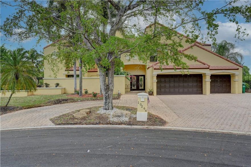 Beyond the manned gates of this quiet little community are tree-lined streets leading you to this 2-story, landscaped home on a beautiful canal-backed 1/2 acre. A few finishing touches can make this a polished gem. With 6 bedrooms, 5 having an en suite bthrm and a bedroom on the first floor, this home can be configured to your taste and needs. MBR has large adjoining room and balcony overlooking the water views. Vaulted ceilings, with wood beam details are gorgeous! Big pool in the back. Great space for entertaining as well. This house will not last! Plenty of parking on driveway and cul-de-sac. Call listing agent for showings. Highest and best offers only!