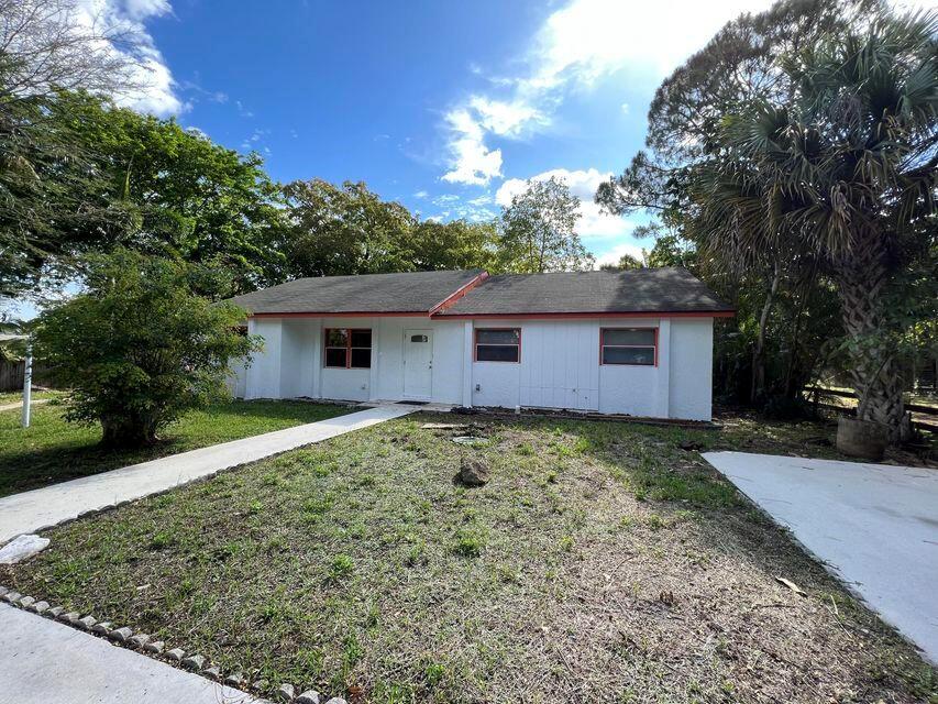 This is a unique single family house located off Lantana Rd in Palm Beach Farms with over 1/2 acre and no HOA. The house is 3 beds/2 full baths, covered screened patio and several storage buildings in the back. You could use as a workshop or just store stuff. Easy to show and move in right away. Schools are excellent and close to shopping and major highways.